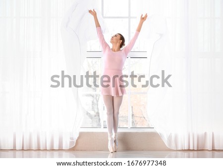 Beautiful young ballerina in dance studio