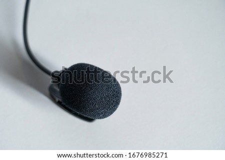 Close up view of lavalier microphone with wind protection isolated on white. Sound recording device concept. Copyspace.