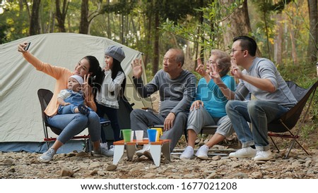 Happy Family Around Camping In The Forest Taking a Selfie And Smiling Nature Tourism Technology Concept.