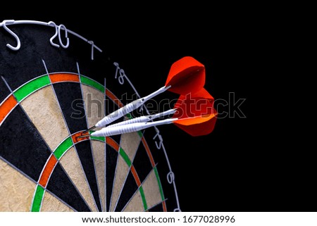Dart arrow hitting in to the dartboard
