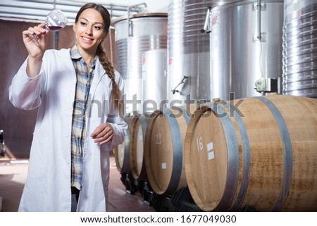woman sommelier is tasting wine at Italian wine factory Royalty-Free Stock Photo #1677049030