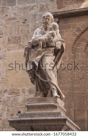 Statues of saints on the background of the Cathedral in Palermo. Sicily. Italy. 