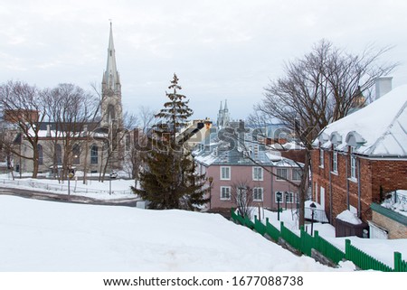 Winter view of patrimonial houses and the neo-Gothic 1853 Chalmers-Wesley United Church seen from St. Denis Avenue, Quebec City, Quebec, Canada Royalty-Free Stock Photo #1677088738