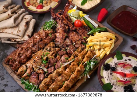 Turkish and Arabic Traditional Ramadan Mix Vali Kebab Plate inside Adana, Urfa, Chicken, Lamb, Liver and Beef on bread 
 Royalty-Free Stock Photo #1677089878