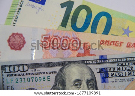 banknotes: one hundred dollars, one hundred euros, five thousand rubles.  exchange rate changes