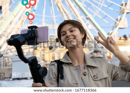 Millennial hipster teen girl blogger influencer record vlog on smart phone holf selfie stick. Travel vlogger shoot video blog instagram story,streaming on urban city street get likes and hearts emoji. Royalty-Free Stock Photo #1677118366