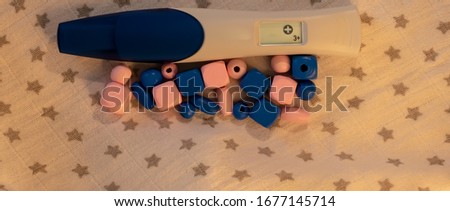pregnancy test with pink and blue objects