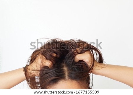 Close up young woman has lice and scratch her hair                               