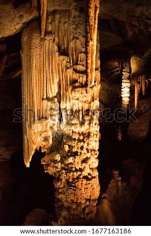 Vertical picture of stalagmites and stalactites in Aven d'Orgnac cavern in Ardeche departement, France. Famous speleology travel tourism destination.