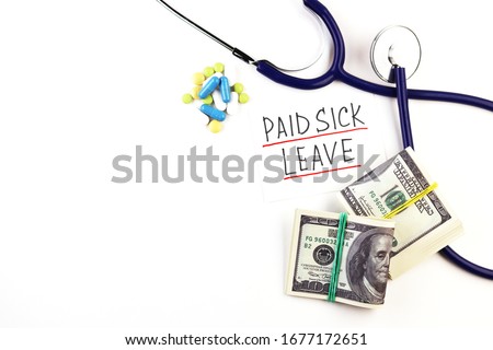 tablets, phonendoscope and paid sick leave lettering on a white background
