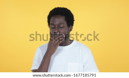 Yawning Casual African Man Isolated on Yellow Background