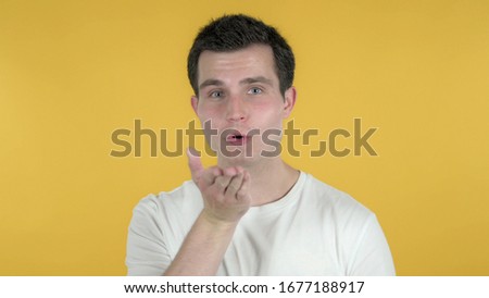 Flying Kiss by Casual Man Isolated on Yellow Background