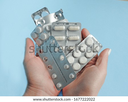 Pills and capsules, healthcare and medicine for virus protection on the blue background close-up                                                                                      