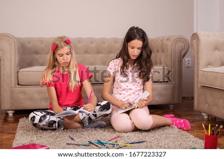 Two girls study at home