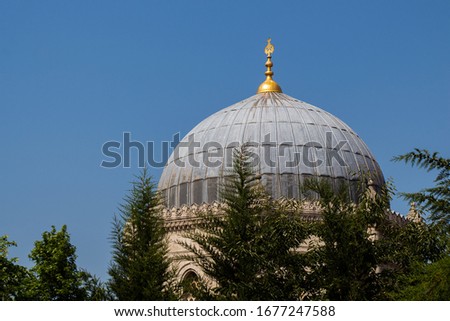 A bottom view shot of the blue building dome with clear sky in the background