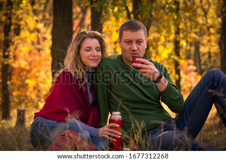 Loving couple resting in the autumn forest
