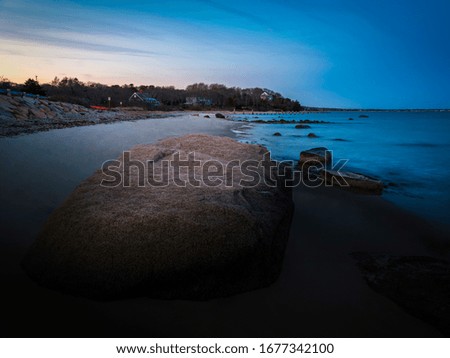 Large boulder on a Cape Cod beach - long exposure photo taken in the evening
