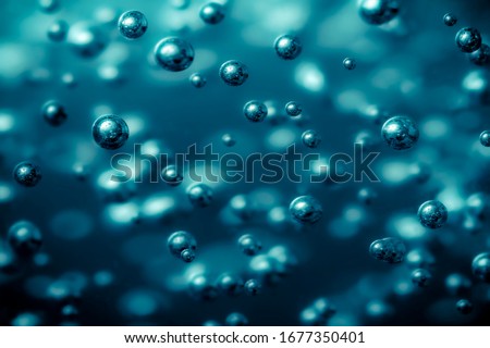 oxygen and hydrogen electrolysis and boiling point. Full frame macro close up photo with selective focus in metallic blue light Royalty-Free Stock Photo #1677350401