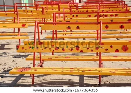Yellow benches with pictures of ladybirds on the beach in Pärnu, Estonia.