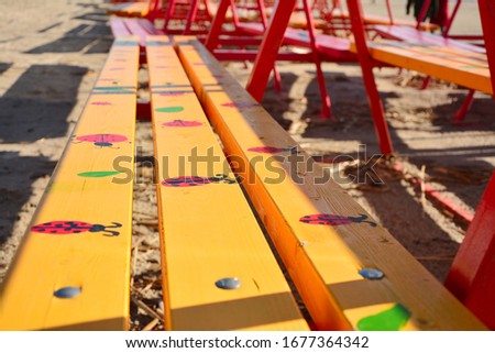 Yellow benches with pictures of ladybirds on the beach in Pärnu, Estonia.
