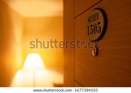 Hotel room door open. Clean and elegant accommodation service.