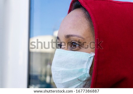 Closeup of african american woman in medical mask looks ahead. Protection against covid-19, virus and infection. People wear mask prevention walking. Royalty-Free Stock Photo #1677386887