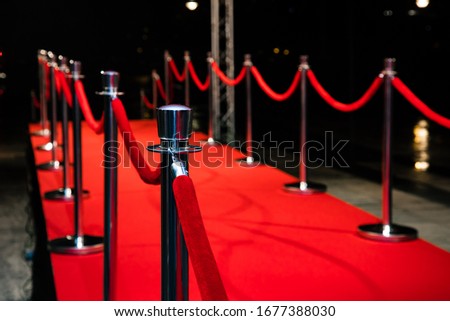 Red carpet with barriers and red ropes. Royalty-Free Stock Photo #1677388030