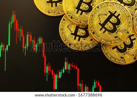 Bitcoin cryptocurrency gold coin. Trading on the cryptocurrency exchange. Trends in bitcoin exchange rates. Rise and fall charts of bitcoin. Royalty-Free Stock Photo #1677388696