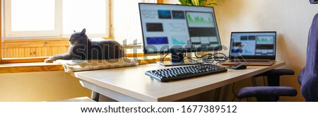 Office at home with IT equipment and online communications. Working from home and remote access concept. Panorama. Royalty-Free Stock Photo #1677389512