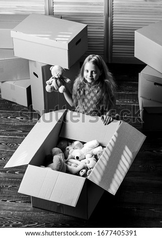 Box package and storage. Small child prepare toys for relocation. Kid girl relocating boxes background. Relocating concept. Delivery service. Happy childhood. Relocating family stressful for kids.