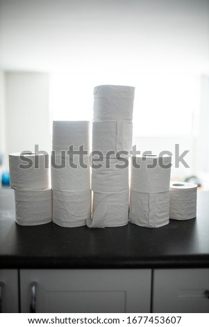  toilet paper bunched up together on a counter in a home