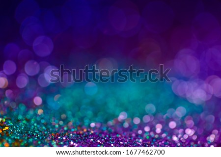 Festive bokeh glitters background, abstract shiny backdrop with circles,modern design overlay with sparkling glimmers. Blue, purple and green backdrop glittering sparks with glow effect Royalty-Free Stock Photo #1677462700