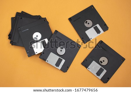 Top view of floppy discs on an orange background