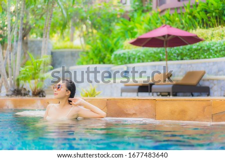 Portrait beautiful young asian woman relax around swimming pool in hotel resort for leisure in vacation