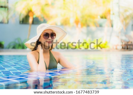 Portrait beautiful young asian woman relax around swimming pool in hotel resort for leisure in vacation