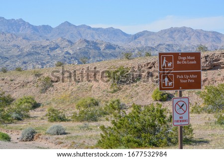 Dogs Must be on a leash and pick up after your pet sign. No fireworks sign at Lake Mead National Recreation Area in Mohave county, Arizona USA