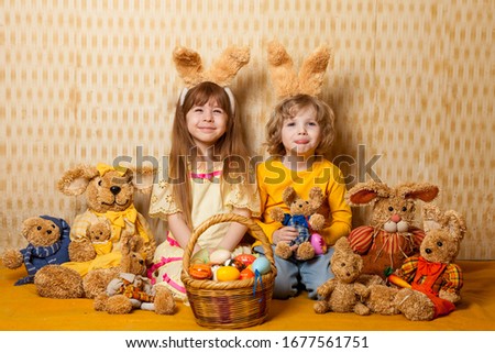 Easter photo of emotional children with a basket of eggs with bunny ears. Easter bunnies preparation for the holiday. funny face. Children awaiting Easter.s. 