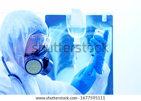 coronavirus or covid-19 concept,Male doctor in a protective suit Giving medicines to patients in the hospital.Lung X-ray Film Destruction Background.shallow focus effect.