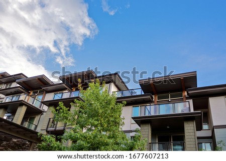 Raising roofs of residential building on blue sky backdrop