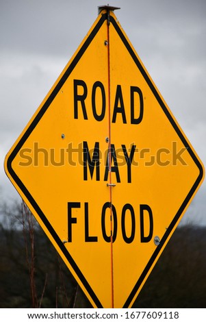 Yellow road may flood sign
