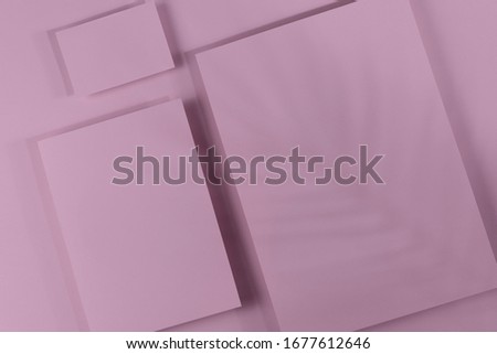 Mosk up. Abstract pink paper background. Three cards of different sizes on a paper background. Shadow falls on an abstract background. Close-up, horizontal, flat lay, lots of free space. Toning pink.