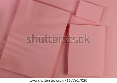 Mosk up. Abstract paper pastel color background. Three cards of different sizes on a paper background. Shadow of leaves falls on the background. Close-up, horizontal, flat lay, free space. Toning.