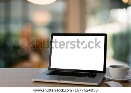 Mockup image of laptop with blank white screen on glass table at outdoor with green nature background light bokeh.- Image Royalty-Free Stock Photo #1677624838