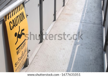 Caution signs Slippery on walkways. selective focus