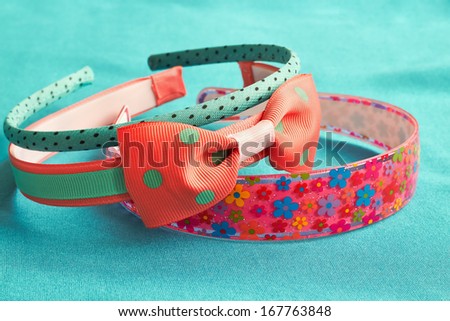  children's colored head bands on a blue background