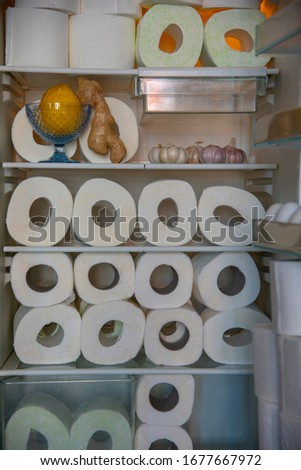 A supply of toilet paper , stored in the refrigerator with garlic, lemon , and ginger. A funny photo that symbolizes the panic of the coronavirus epidemic.