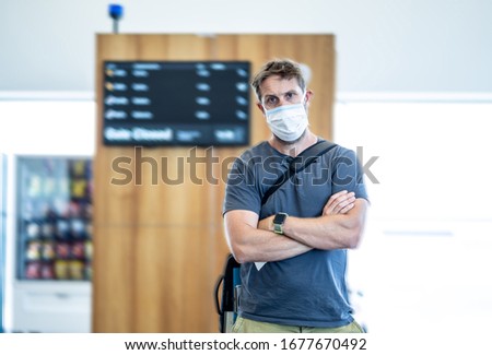Coronavirus outbreak travel restrictions. Travelers with face mask at international airport affected by flight cancellation and travel ban. COVID-19 pandemic and worldwide Borders closures. Royalty-Free Stock Photo #1677670492