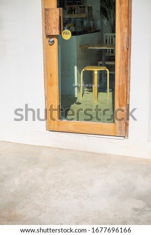 Door restaurant entrance "open hours"on the through window glass 