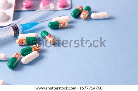 Coronavirus phrase text on a white background with medicines and a syringe. 2019-nCoV. Wuhan, China 2New Coronavirus - 2019-nKoV.
