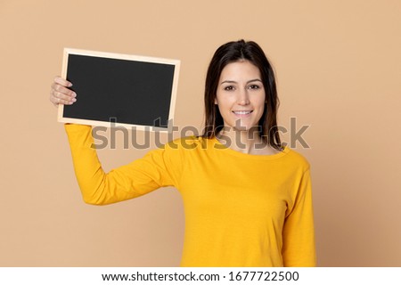 Attractive young girl wearing a T-shirt on a yellow background